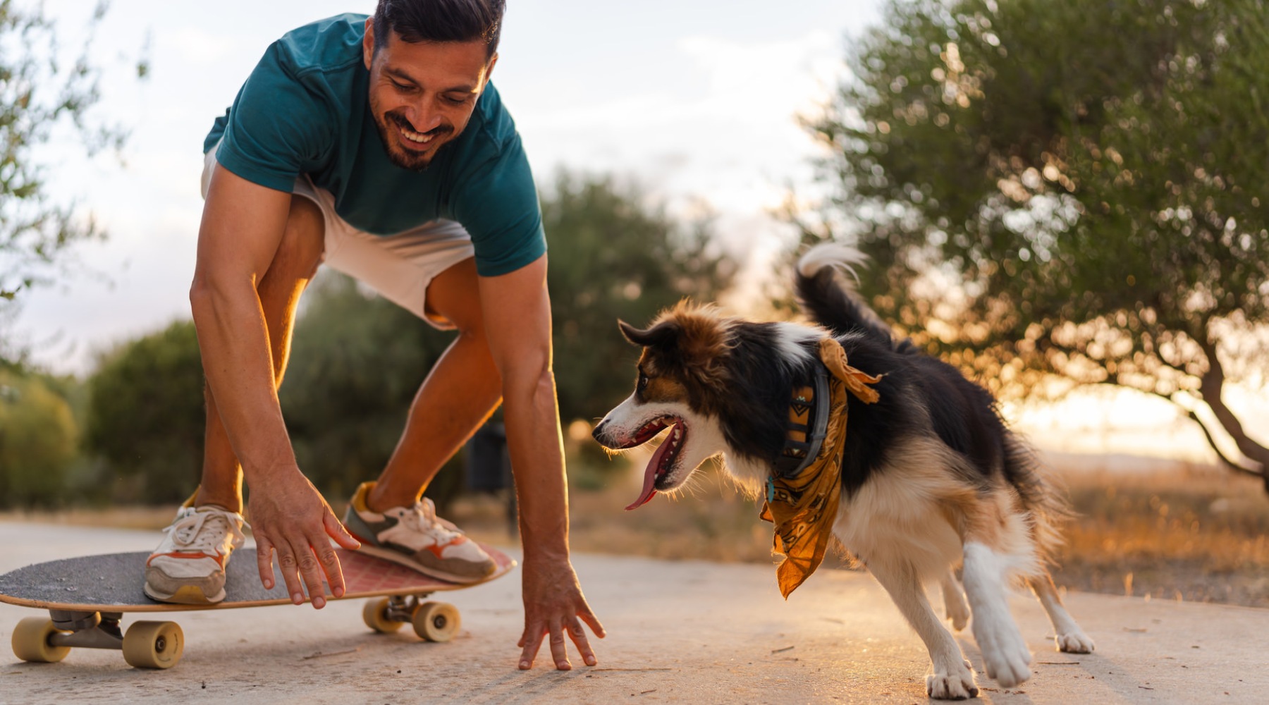 a man on a skateboard with a dog