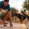 a man on a skateboard with a dog