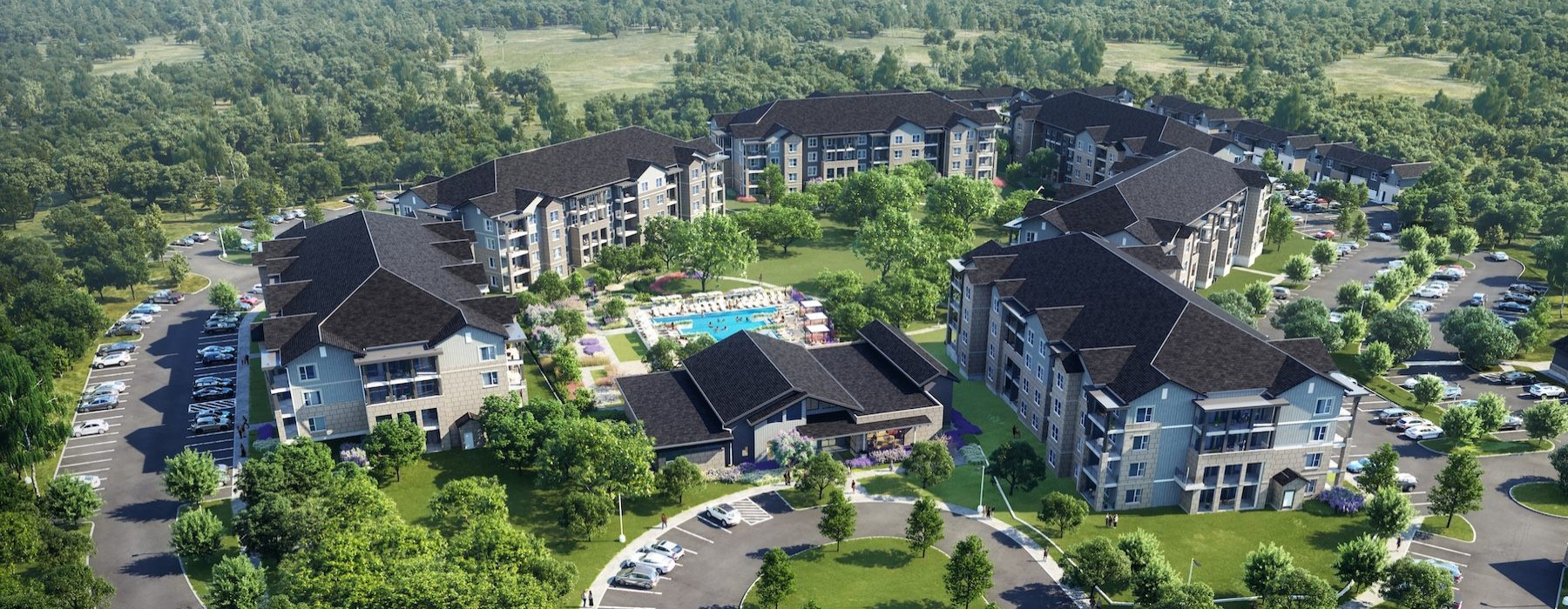 aerial view of pool and building with several trees
