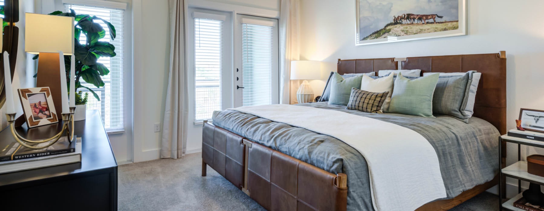 a bedroom with large windows