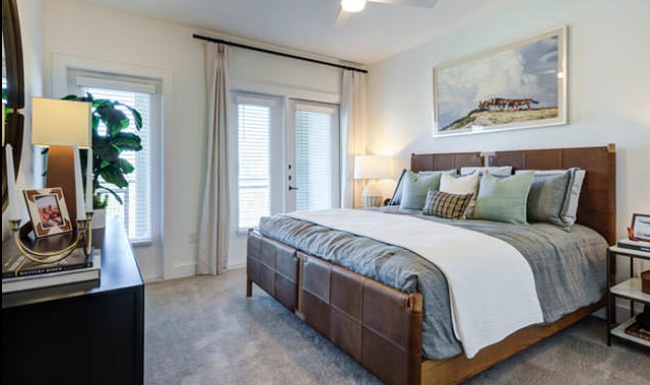 a bedroom with large windows